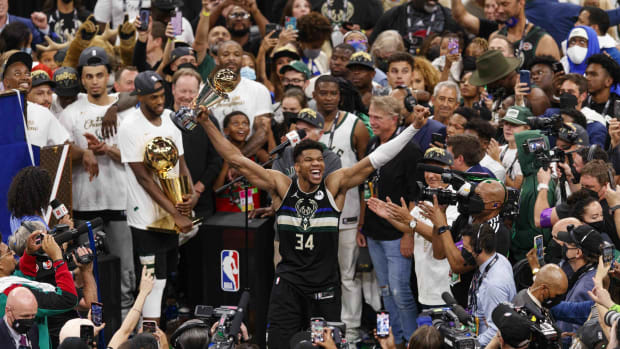 Milwaukee Bucks forward Giannis Antetokounmpo (34) celebrates with the NBA Finals MVP Trophy